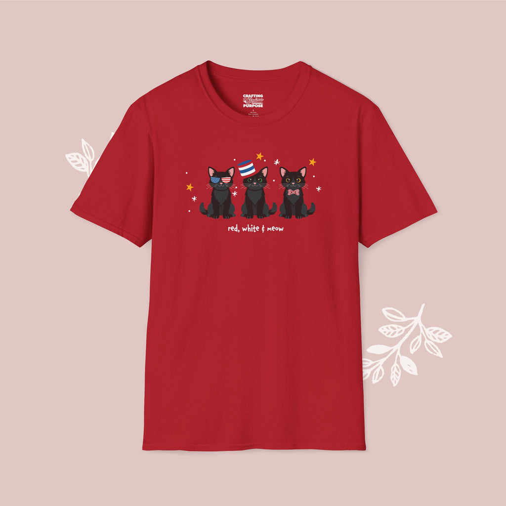 Red t-shirt with black cat illustration and text on a pink background