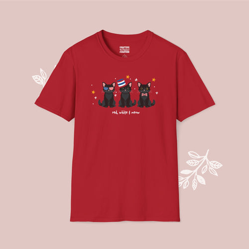Red t-shirt with black cat illustration and text on a pink background
