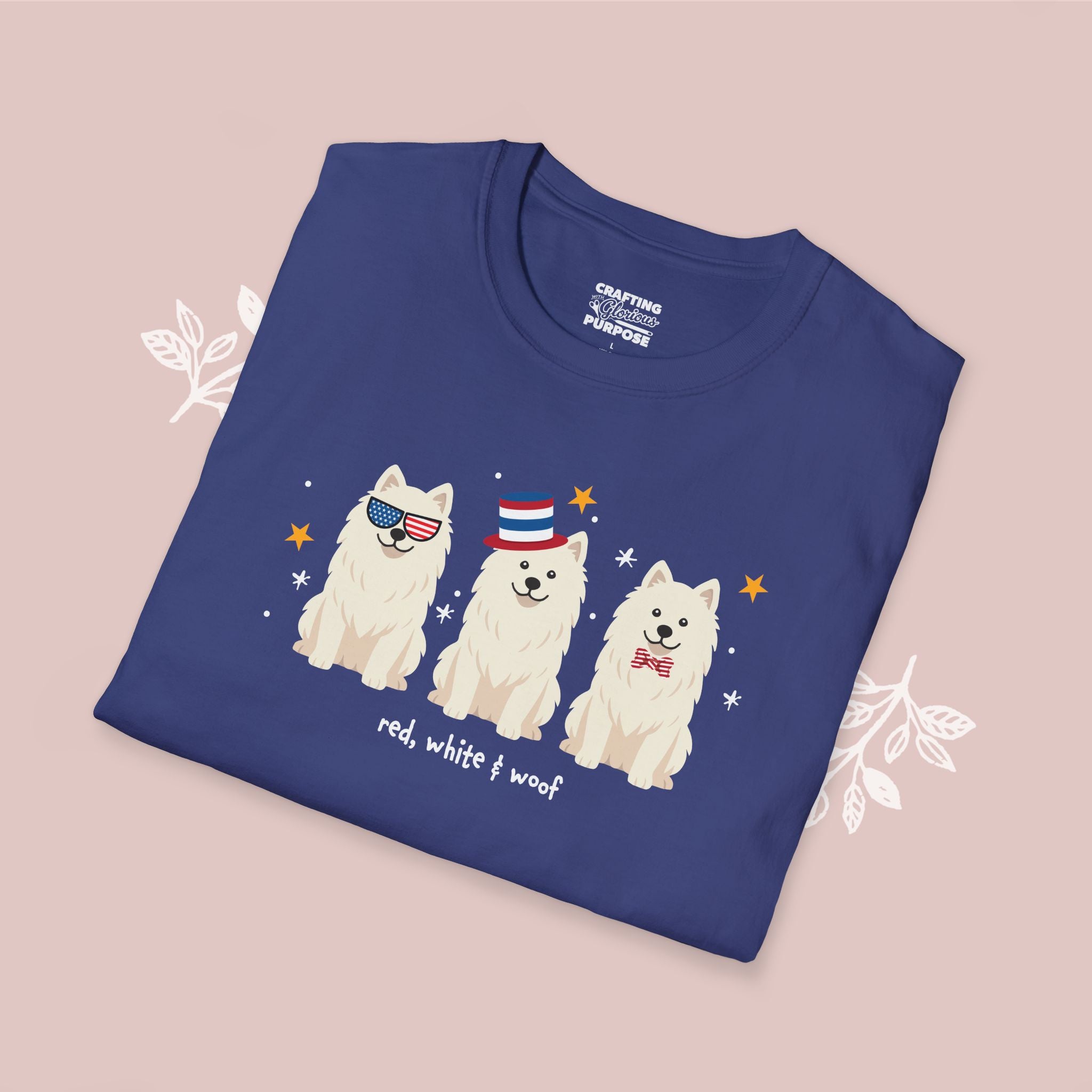 Folded blue t-shirt with dog illustrations and text on a pink background