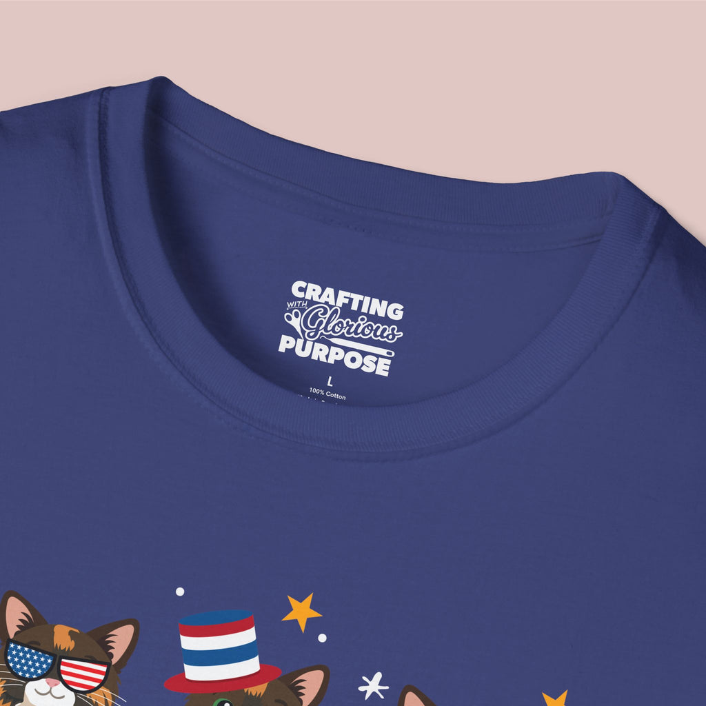 Navy blue t-shirt with a graphic of a cat wearing an American flag hat and text on a beige background