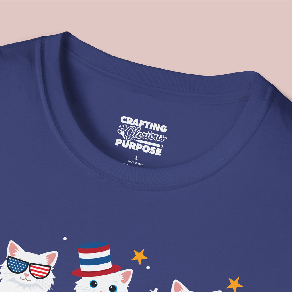 Navy blue t-shirt with a graphic of cats wearing American flags and a slogan on a beige background