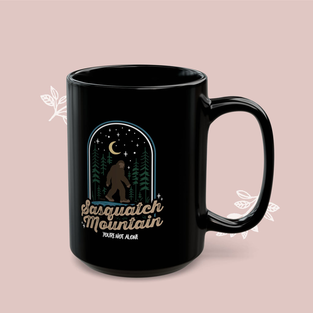 Sasquatch Mountain Black Mug — 'You're Not Alone' Retro Design