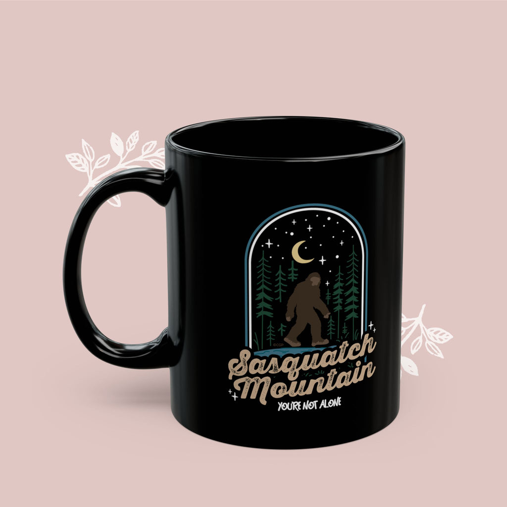 Sasquatch Mountain Black Mug — 'You're Not Alone' Retro Design