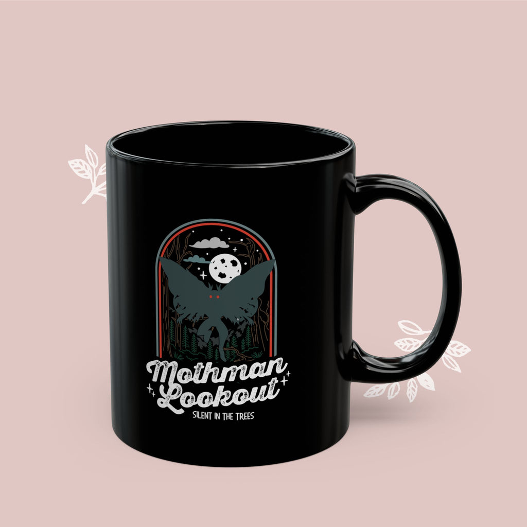 Black mug with white text on a white background