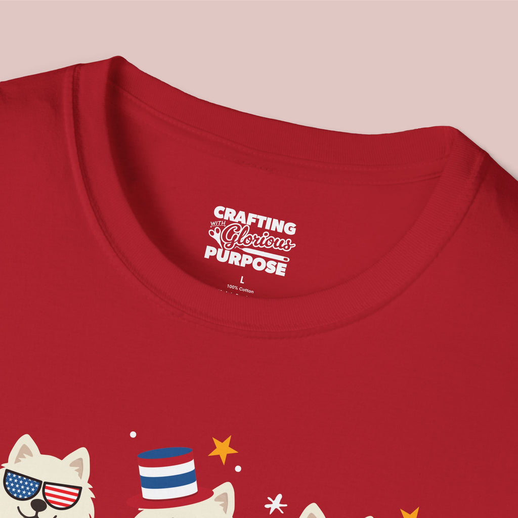 Red t-shirt with a graphic of a dog wearing an American flag hat and sunglasses, and text 'Crafting a Glorious Purpose' on a pink background.