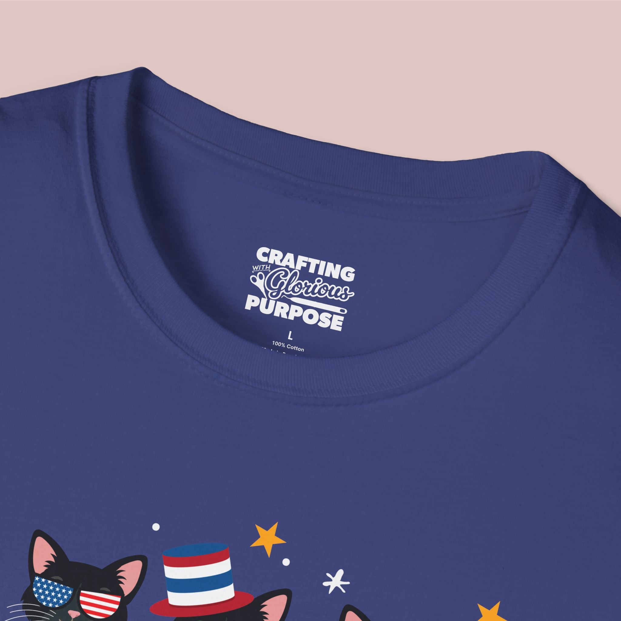 Navy blue t-shirt with a graphic of a cat wearing an American flag hat and stars, and text on the collar.