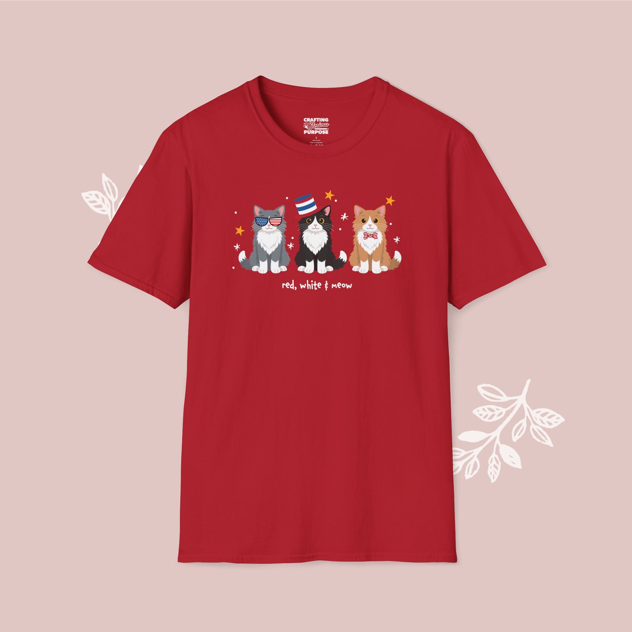 Red t-shirt with cat illustrations and text on a pink background