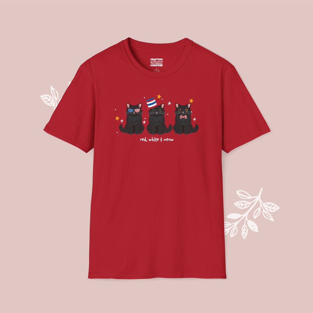 Red t-shirt with black cat illustration and text on a pink background