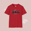 Red t-shirt with black cat illustration and text on a pink background