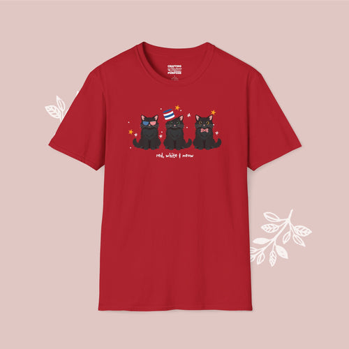 Red t-shirt with black cat illustration and text on a pink background