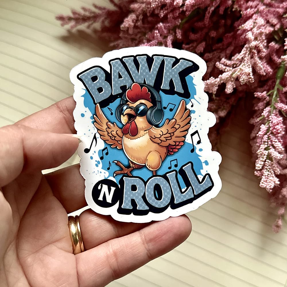 Sticker with a chicken and 'BAWK N ROLL' text held by a hand, with pink flowers in the background.