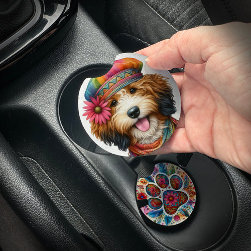 Hand placing a colorful car coaster with a dog design into a car cup holder.