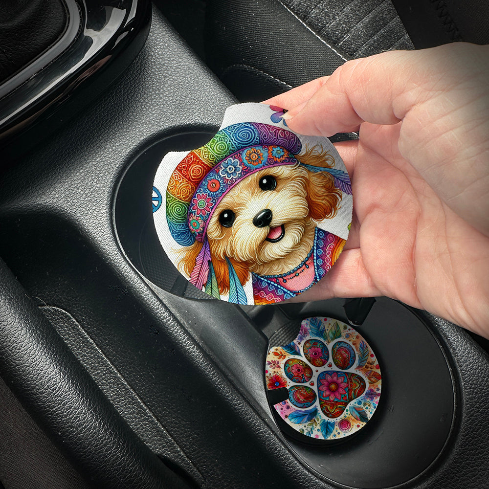 Hand placing a colorful car coaster with a dog design into a car cup holder.