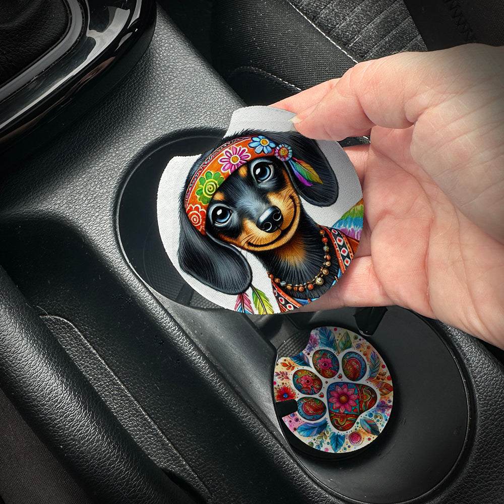 Hand placing a colorful car coaster with a dog design into a car cup holder.