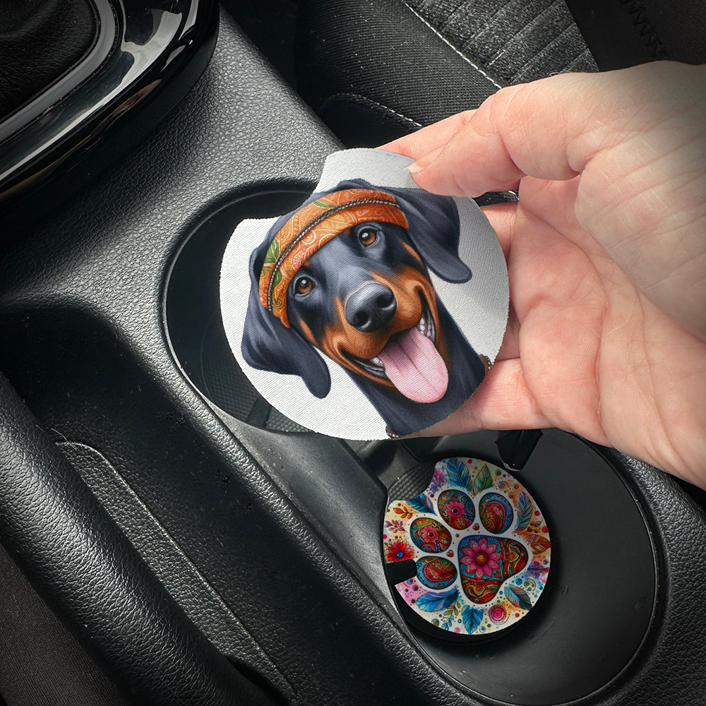 Hand placing a colorful car coaster with a dog design into a car cup holder.