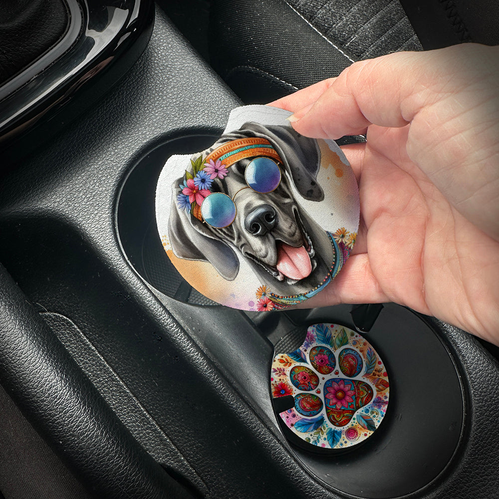 Hand placing a colorful car coaster with a dog design into a car cup holder.