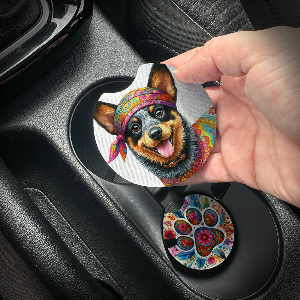 Hand placing a colorful car coaster with a dog design into a car cup holder.