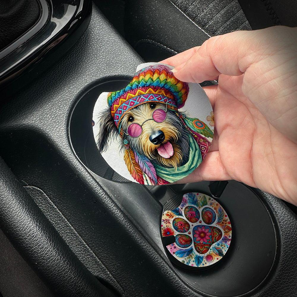 Hand placing a colorful car coaster with a dog design into a car cup holder.