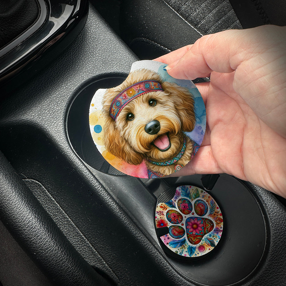 Hand placing a colorful car coaster with a dog design into a car cup holder.