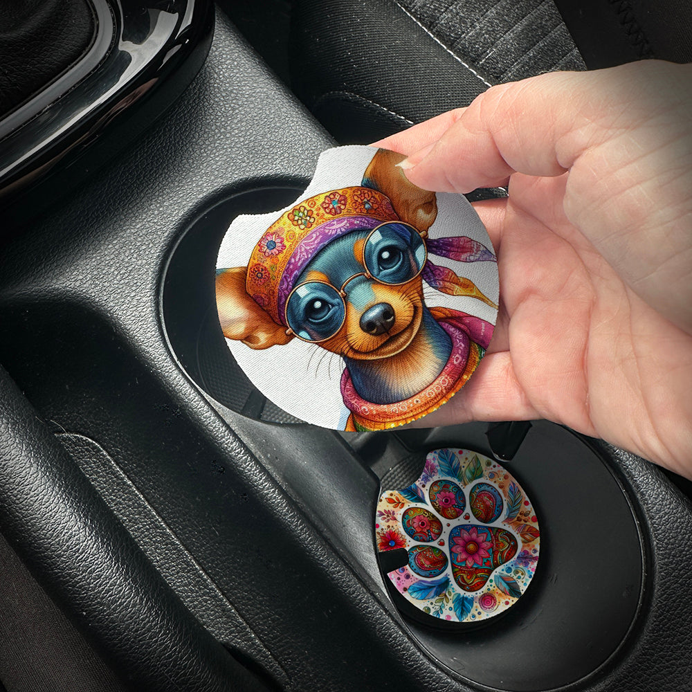 Hand placing a colorful car coaster with a dog design into a car cup holder.