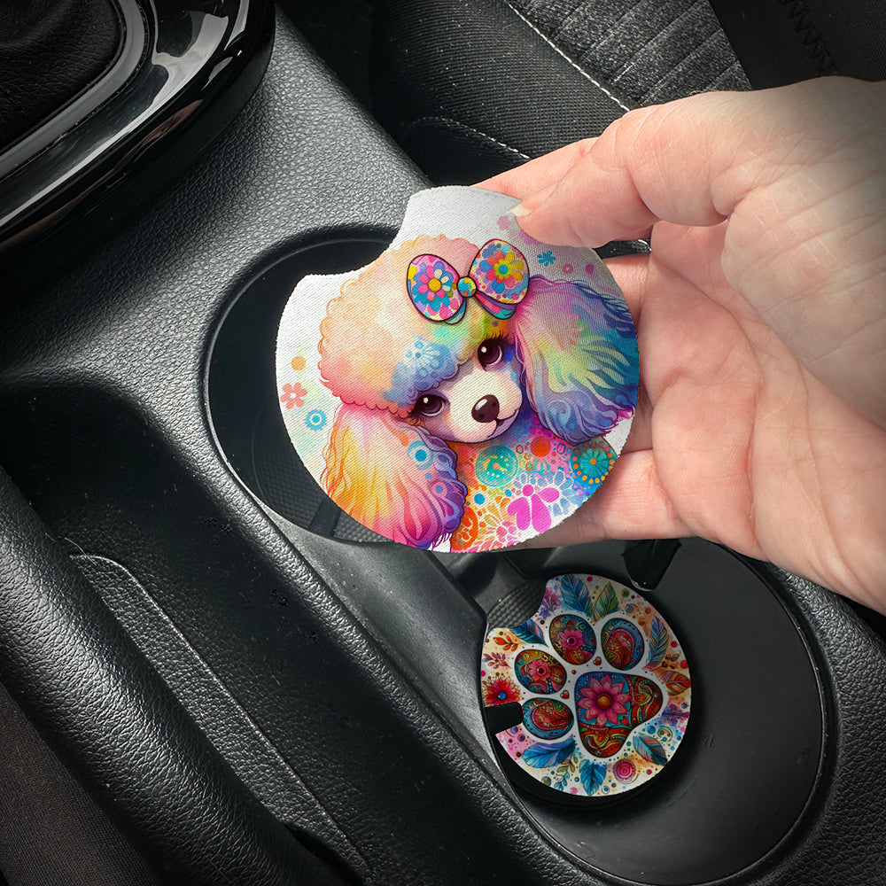 Hand placing a colorful car coaster with a dog design into a car cup holder.