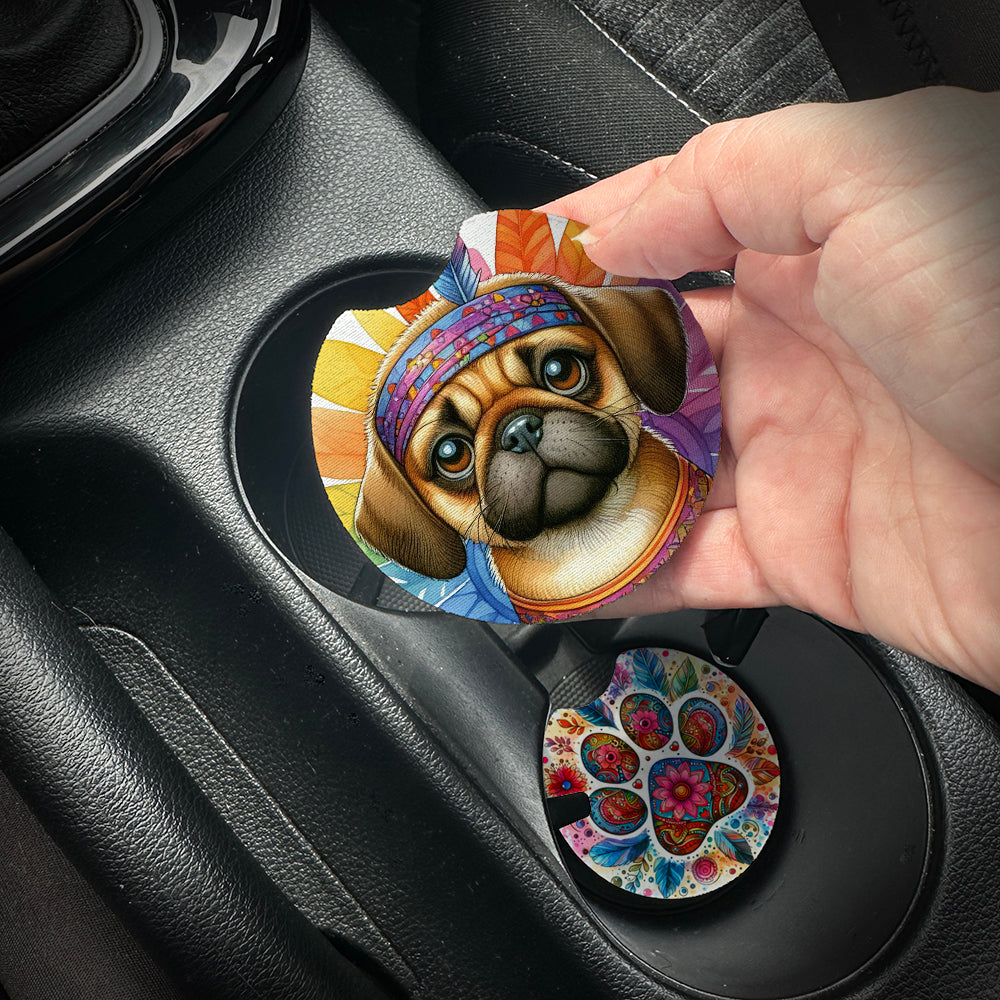 Hand placing a colorful car coaster with a dog design into a car cup holder.