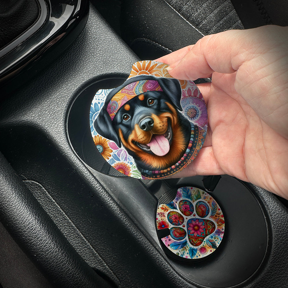Hand placing a colorful car coaster with a dog design into a car cup holder.