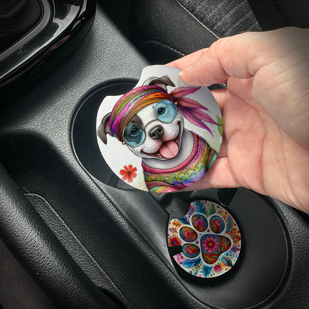 Hand placing a colorful car coaster with a dog design into a car cup holder.