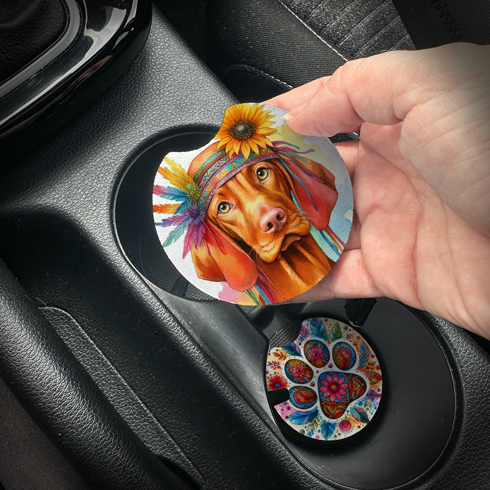 Hand placing a colorful car coaster with a dog design into a car cup holder.