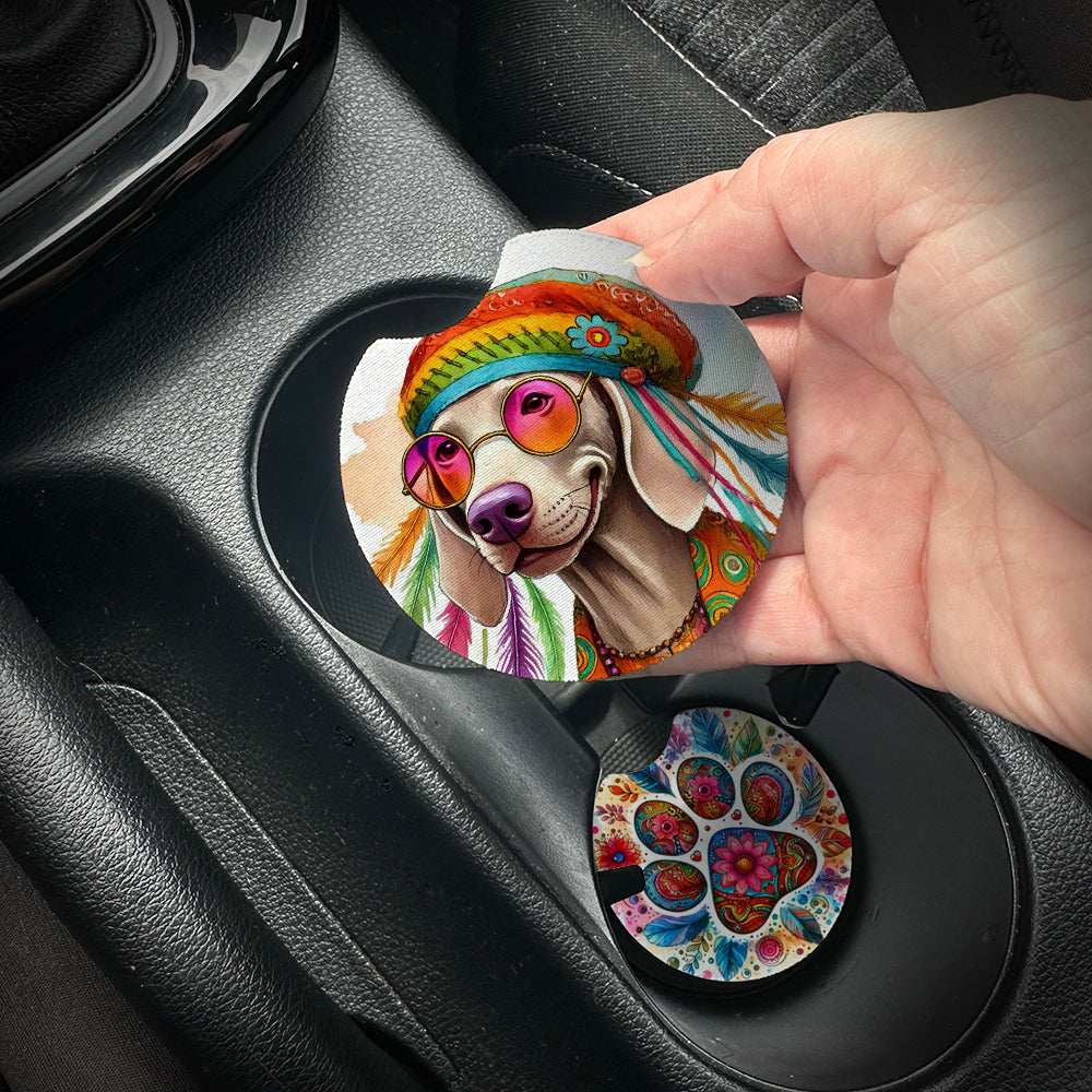 Hand placing a colorful car coaster with a dog design into a car cup holder.