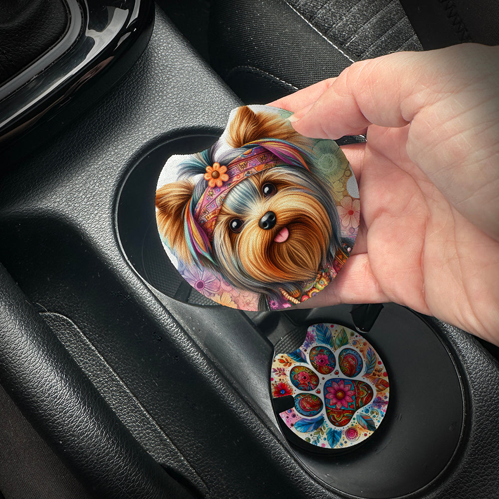 Hand placing a colorful car coaster with a dog design into a car cup holder.