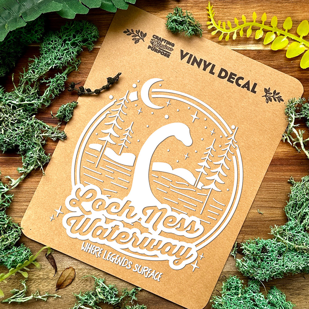 Vinyl decal of Loch Ness Waterway on a brown card with greenery around