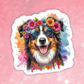Dog with floral headband and colorful glasses on a pink background