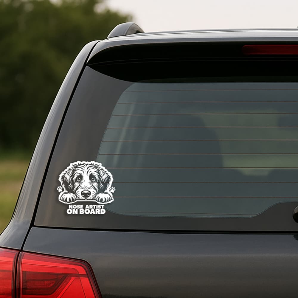Car window with a dog-themed 'Nose Artist on Board' decal.