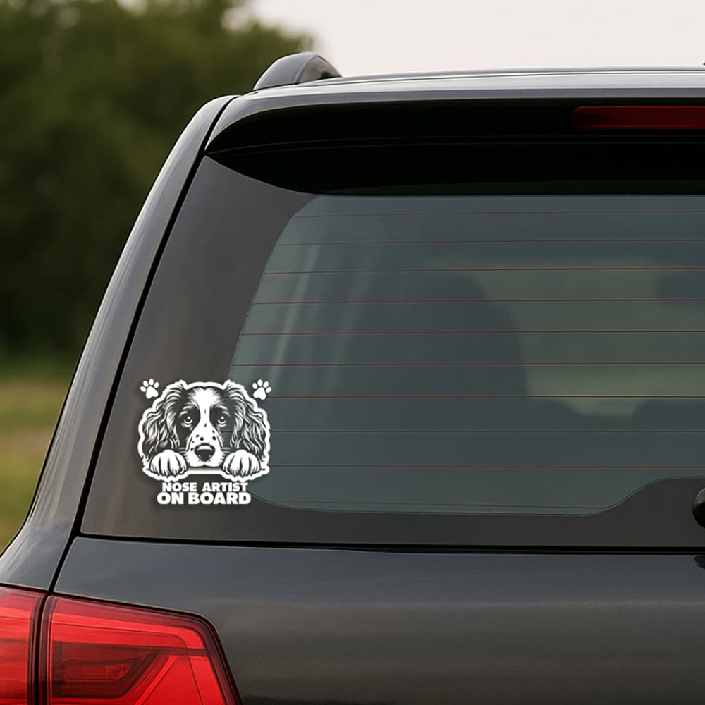 Car with a dog-themed decal on the back window, featuring text 'None Artist On Board'.