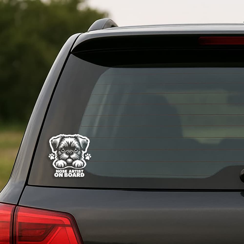 Car window with a dog-themed 'Nose Artist on Board' decal.