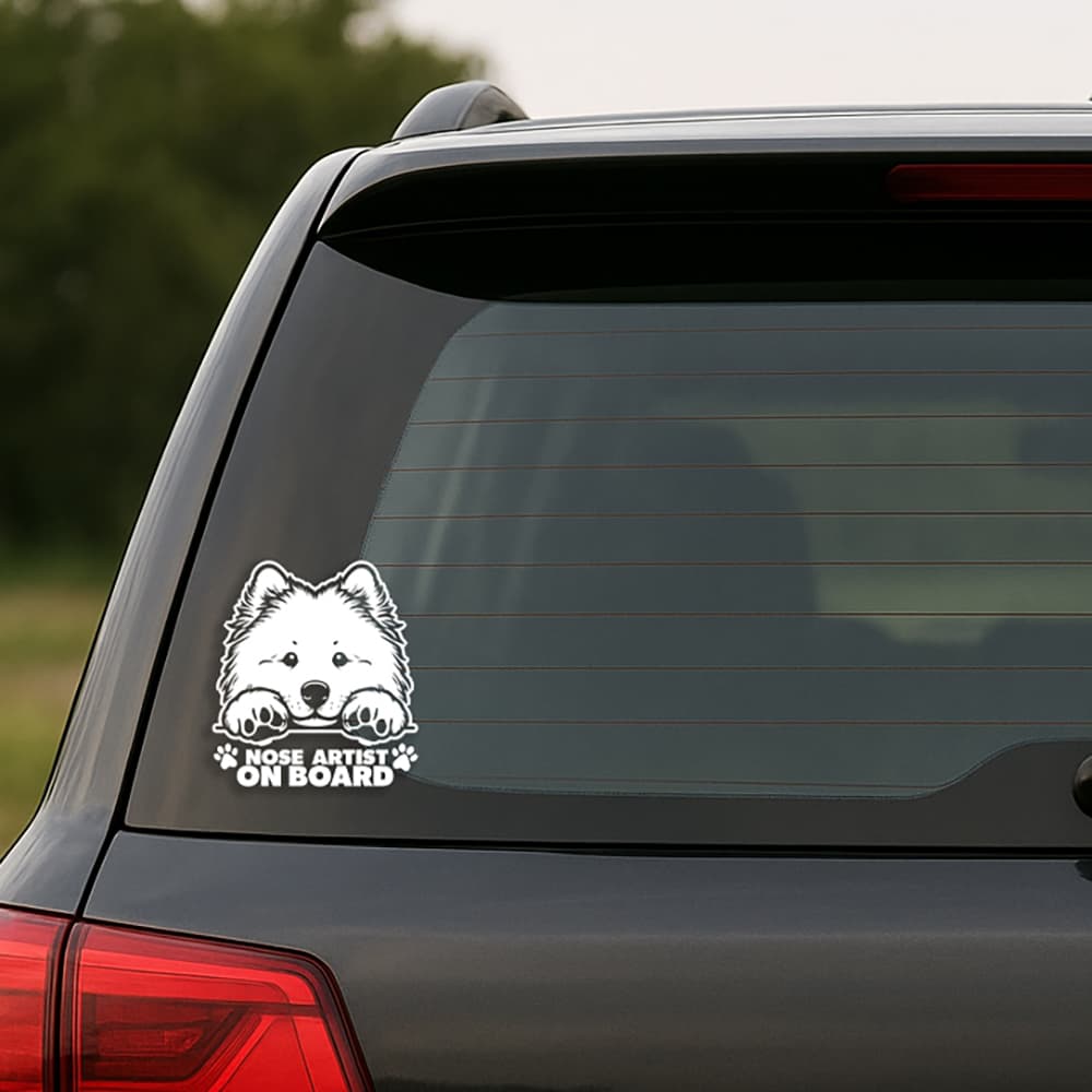 Car window with a dog-themed 'Nose Artist on Board' decal.