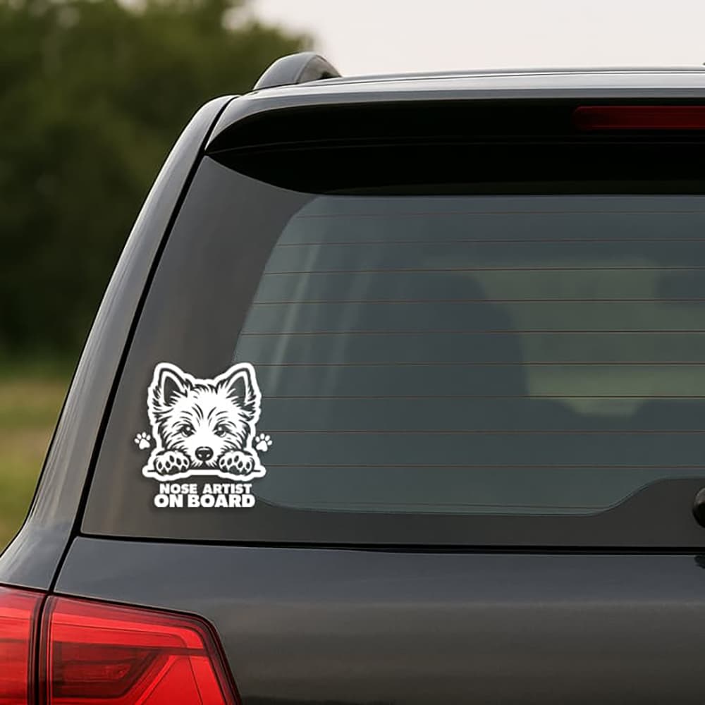 Car window with a dog-themed 'Nose Artist on Board' decal.