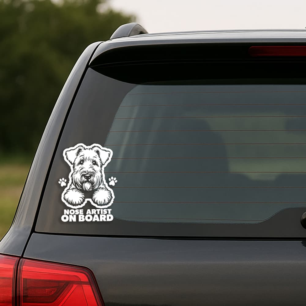 Car window with a dog-themed 'Nose Artist on Board' decal.