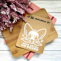 Vinyl decal with a dog illustration and text on a wooden surface with pink flowers.