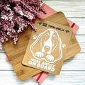 Vinyl decal with a dog illustration and text on a wooden surface with pink flowers.