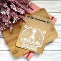 Vinyl decal with a dog illustration and text on a wooden surface with pink flowers.