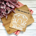 Vinyl decal with a dog illustration and text on a wooden surface with pink flowers.