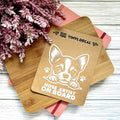 Vinyl decal with a dog illustration and text on a wooden surface with pink flowers.