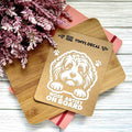 Vinyl decal with a dog illustration and text on a wooden surface with pink flowers.