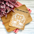 Vinyl decal with a dog illustration and text on a wooden surface with pink flowers.