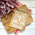 Vinyl decal with a dog illustration and text on a wooden surface with pink flowers.