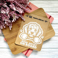 Vinyl decal with a dog illustration and text on a wooden surface with pink flowers.
