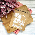 Vinyl decal with a dog illustration and text on a wooden surface with pink flowers.