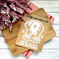 Vinyl decal with a dog illustration and text on a wooden surface with pink flowers.